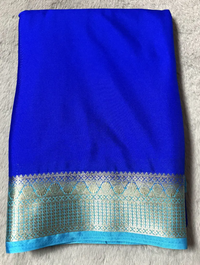 [E-COM019] Royal blue Crepe silk saree featuring a sky blue and gold zari woven border